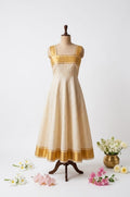 ethnic fusion dress features an off-white and metallic gold kasavu-inspired design.