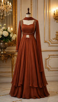 rust-brown ethnic ensemble features a contemporary layered silhouette with refined hand work